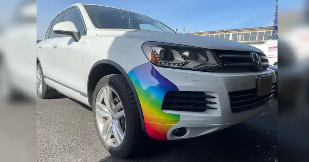 Volkswagen driving out of Vinyl Wrap Toronto garage after front bumper stickers installation.