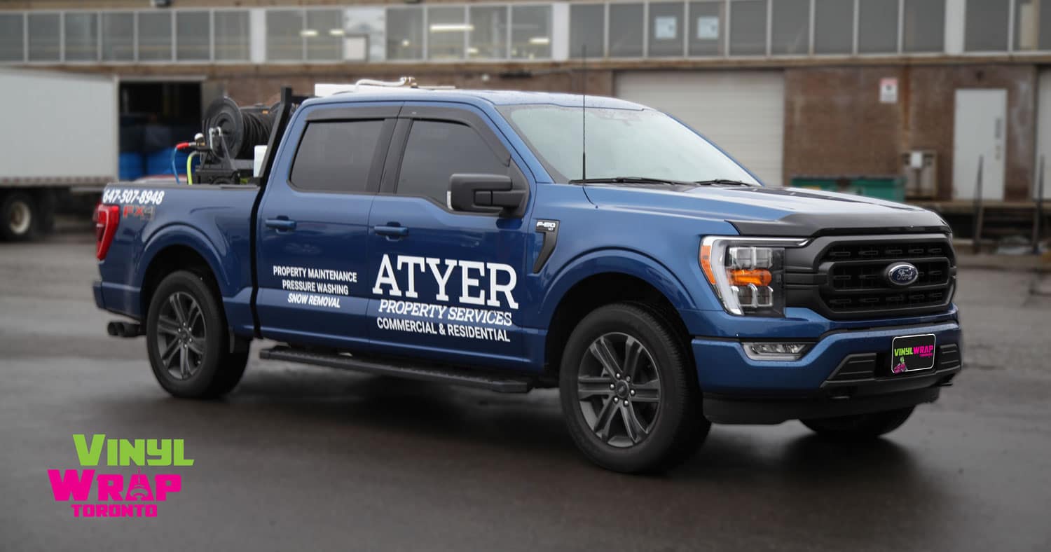 Blue pickup truck with white ATYER Property Services Logo to showcase DIY vs. Professional truck decal